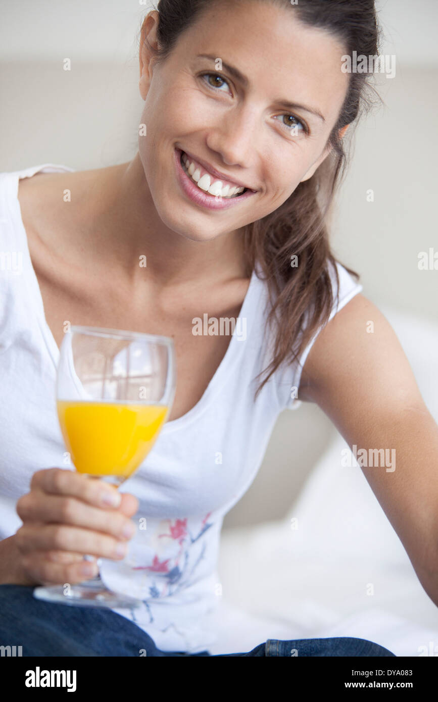 Young woman drinking glass of orange juice Stock Photo