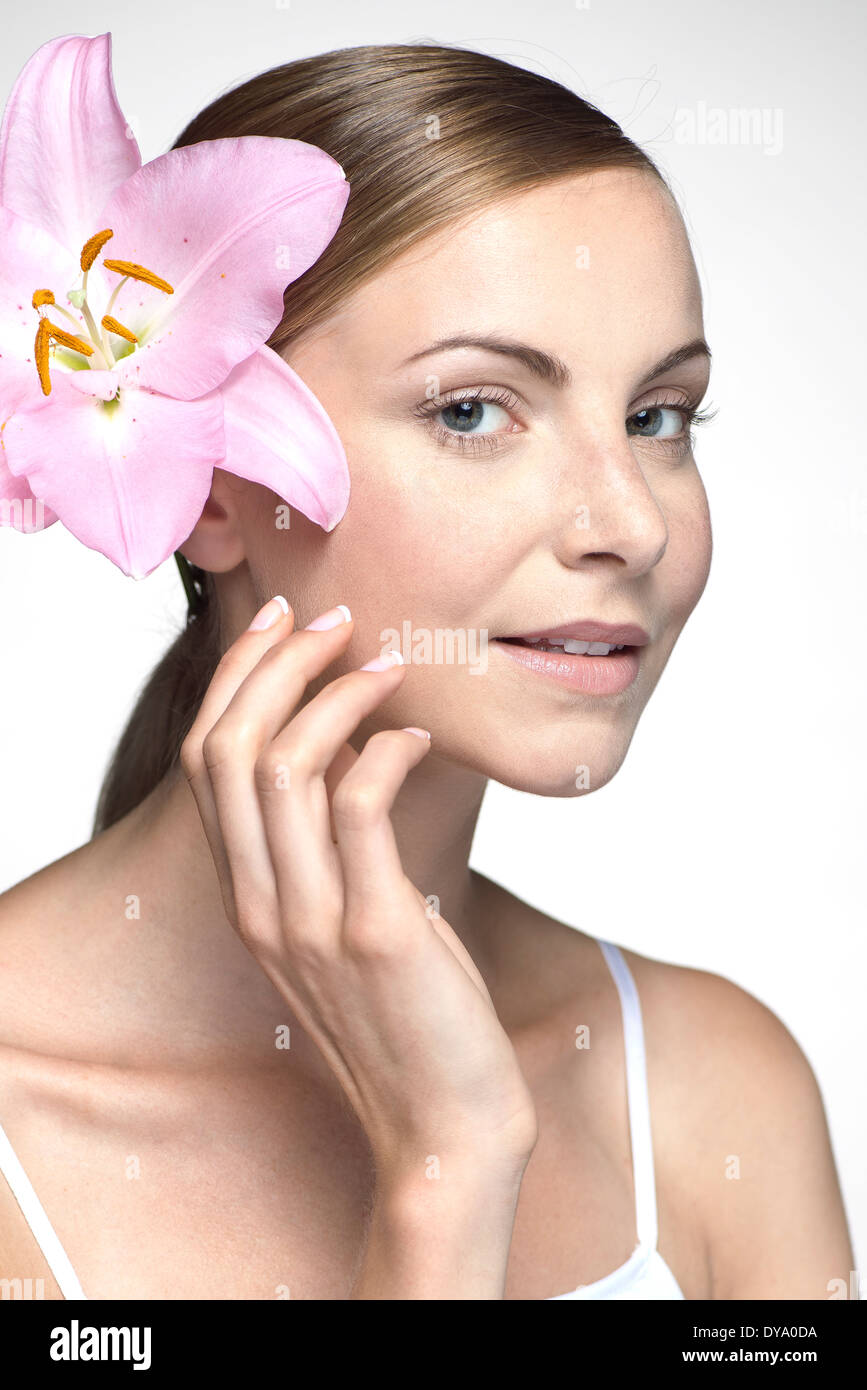 Young woman with orchid in hair Stock Photo