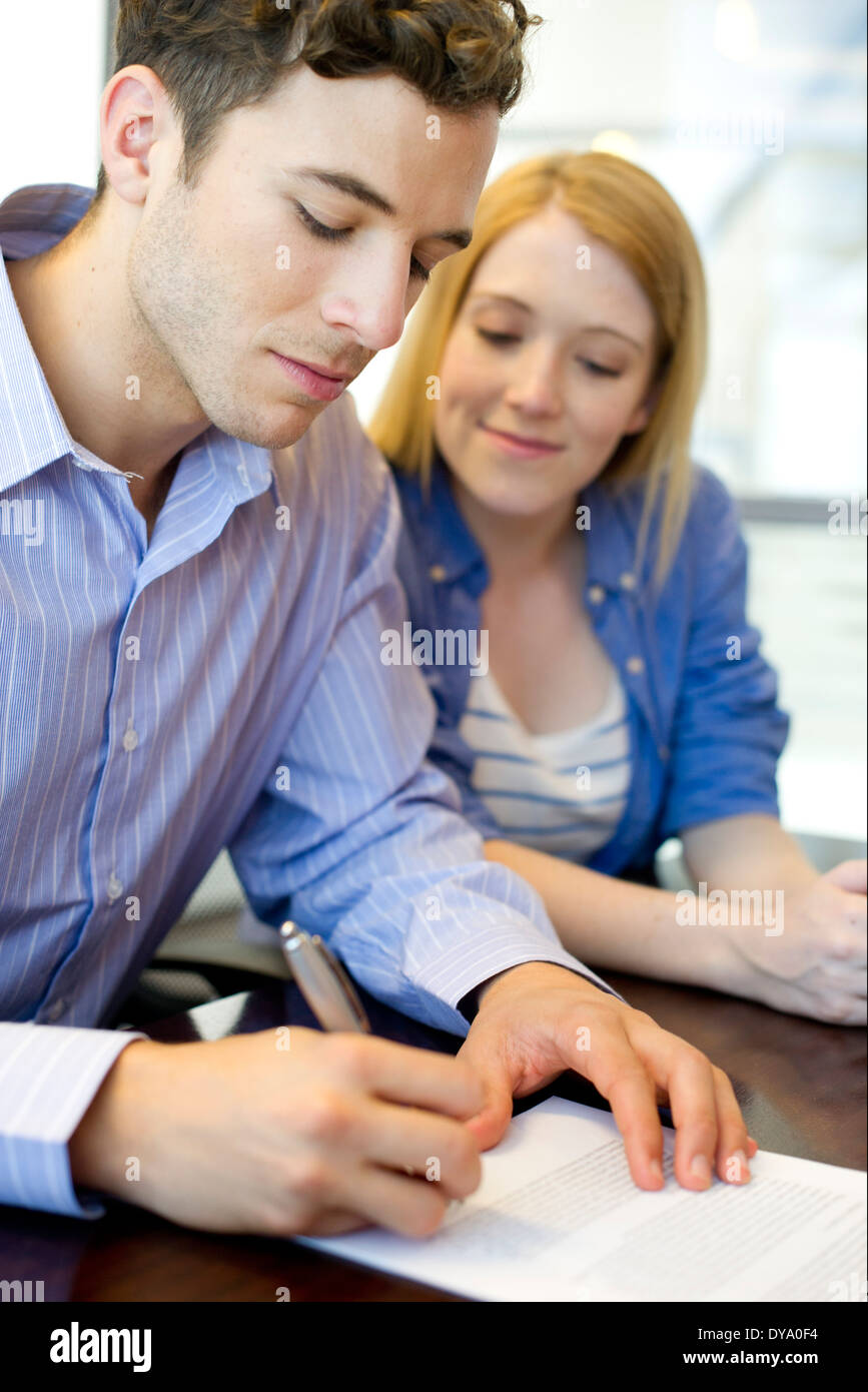 Man signing paperwork in office Stock Photo Alamy