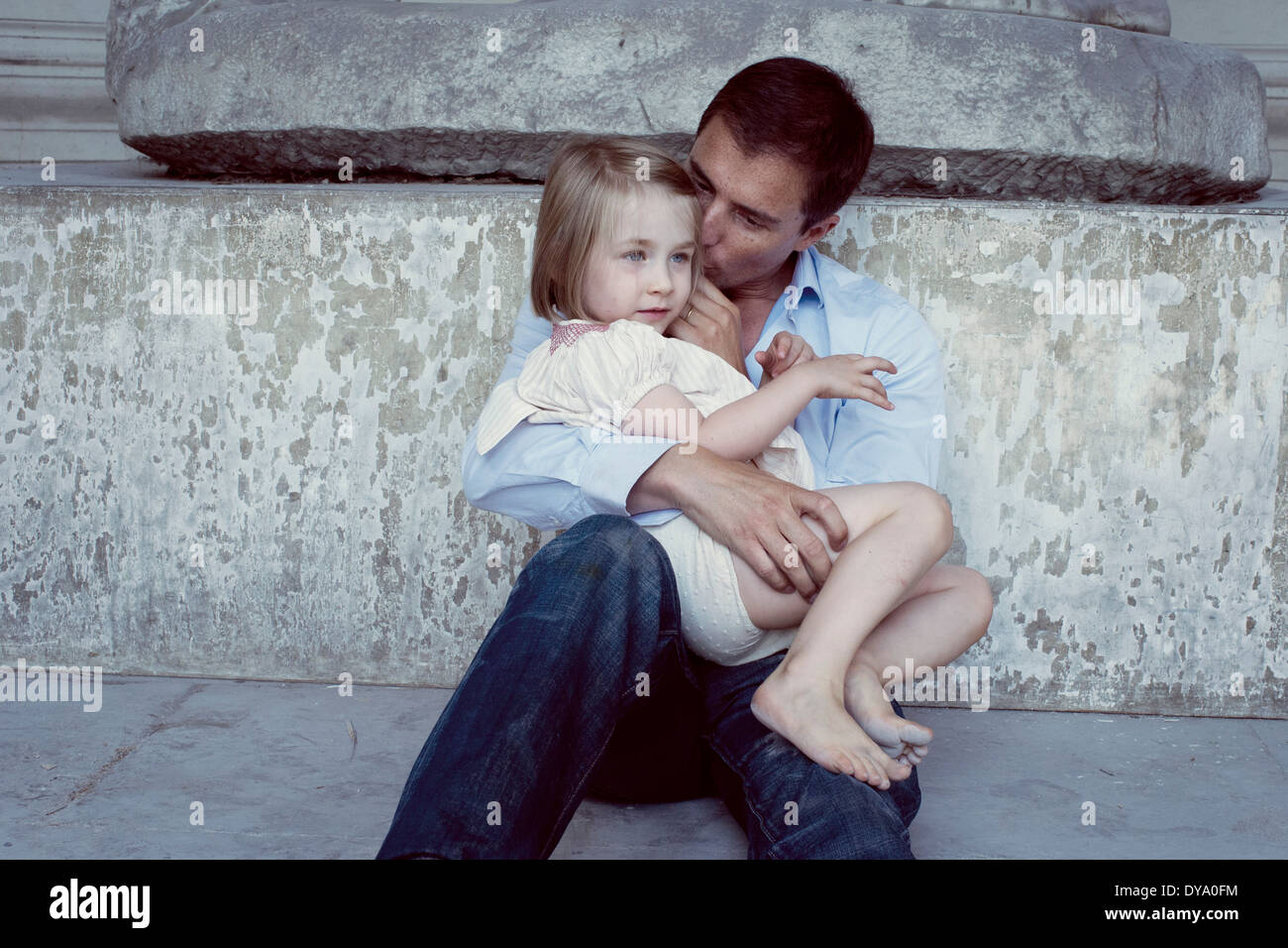 Father holding young daughter on his lap Stock Photo