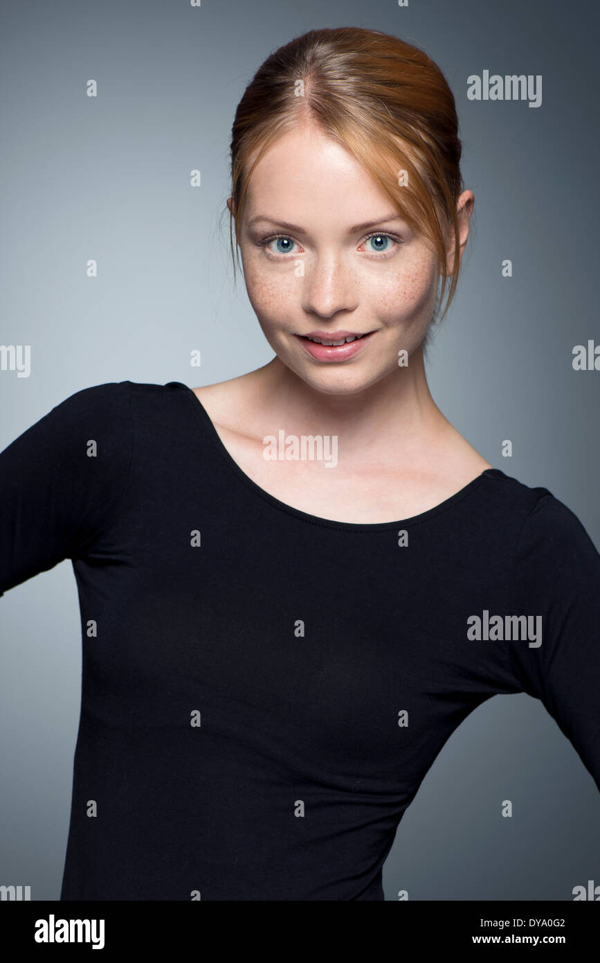 Young woman with hands on hips, portrait Stock Photo