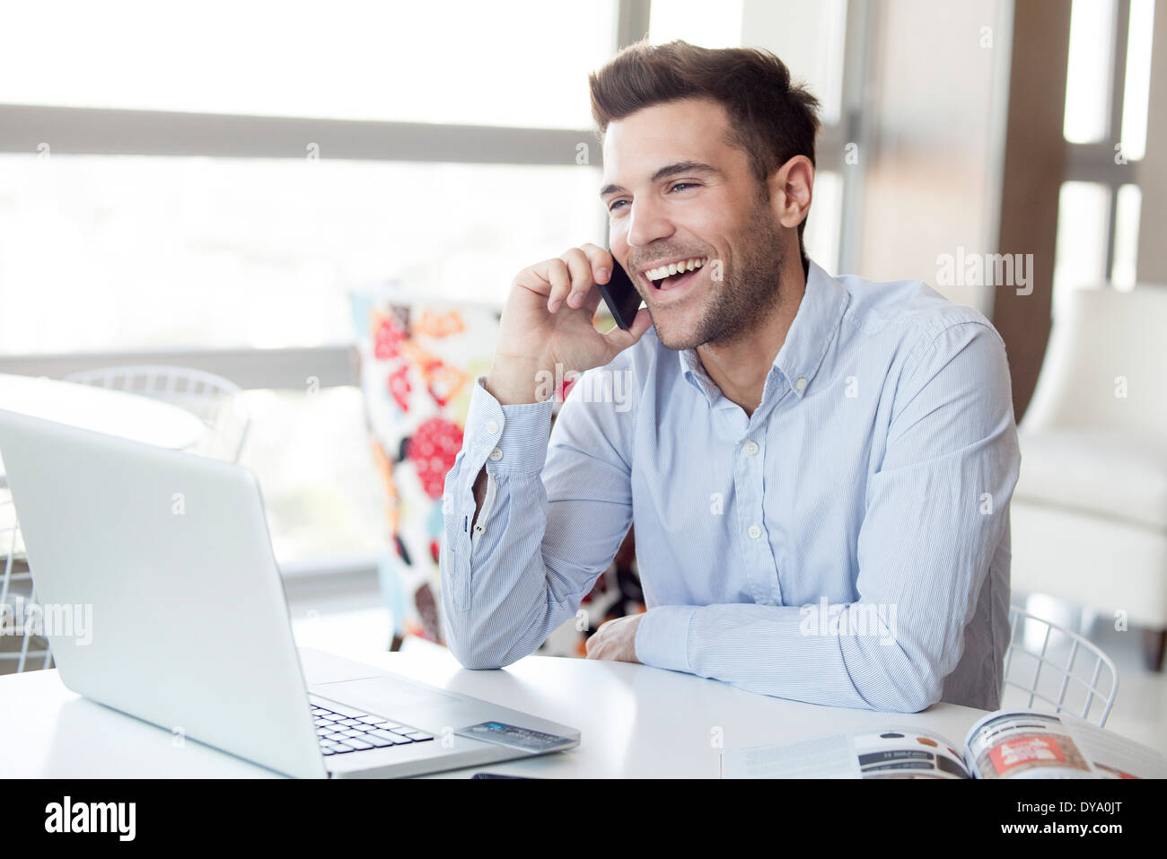 Man making cell phone call at home Stock Photo - Alamy