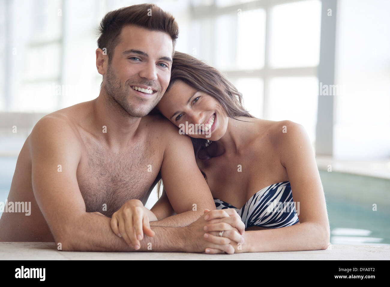 Young couple in pool together, portrait Stock Photo