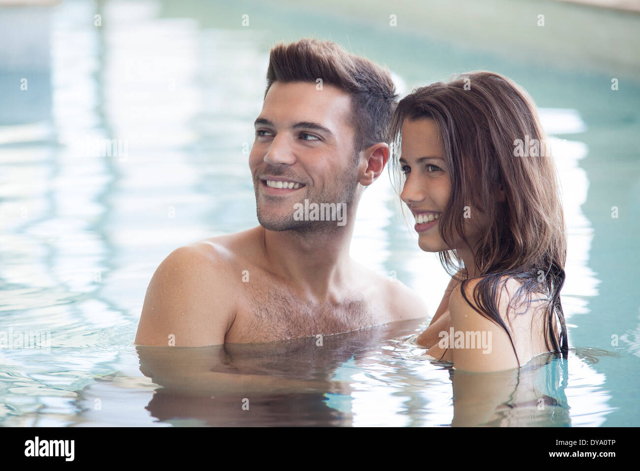 Couple relaxing together in pool Stock Photo Alamy