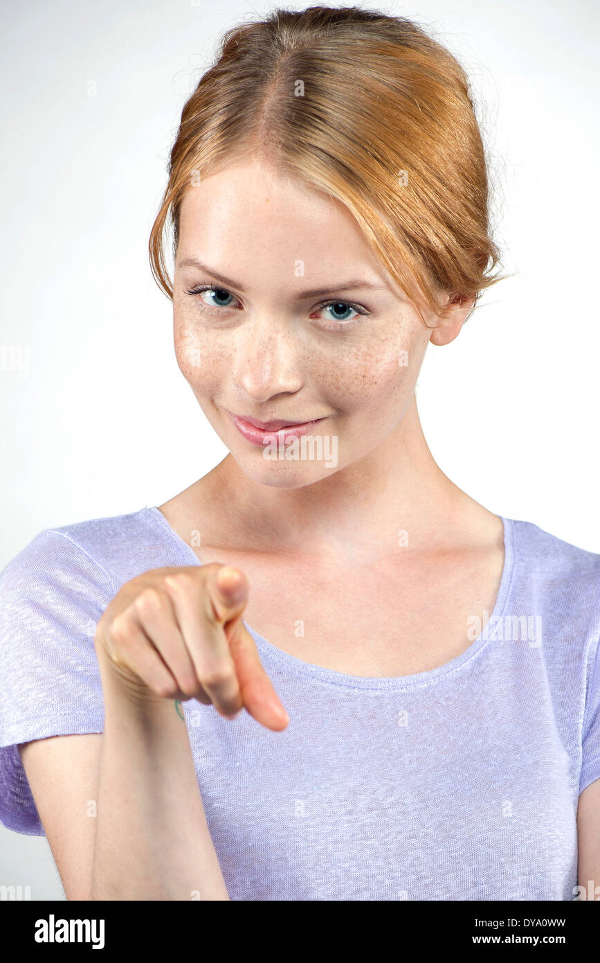 Young woman pointing at viewer Stock Photo