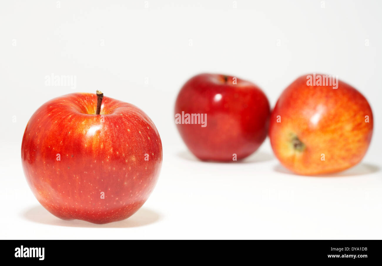 three nice red juicy apples on white sheet Stock Photo