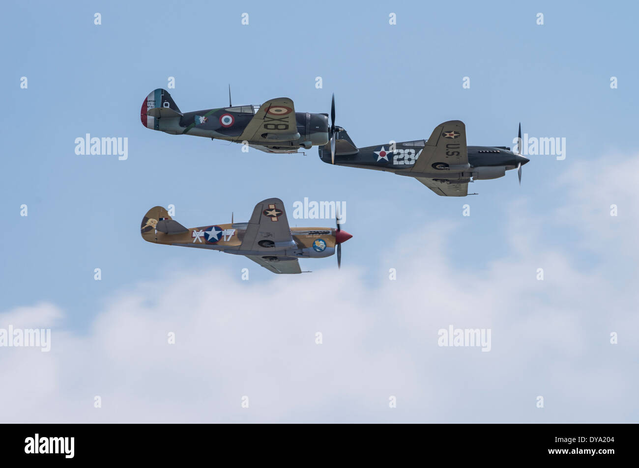 Curtiss H75A-1 Hawk and Curtiss P-40B and P-40F Warhawks in formation at the Flying Legends Airshow, Imperial War Museum Duxford Stock Photo