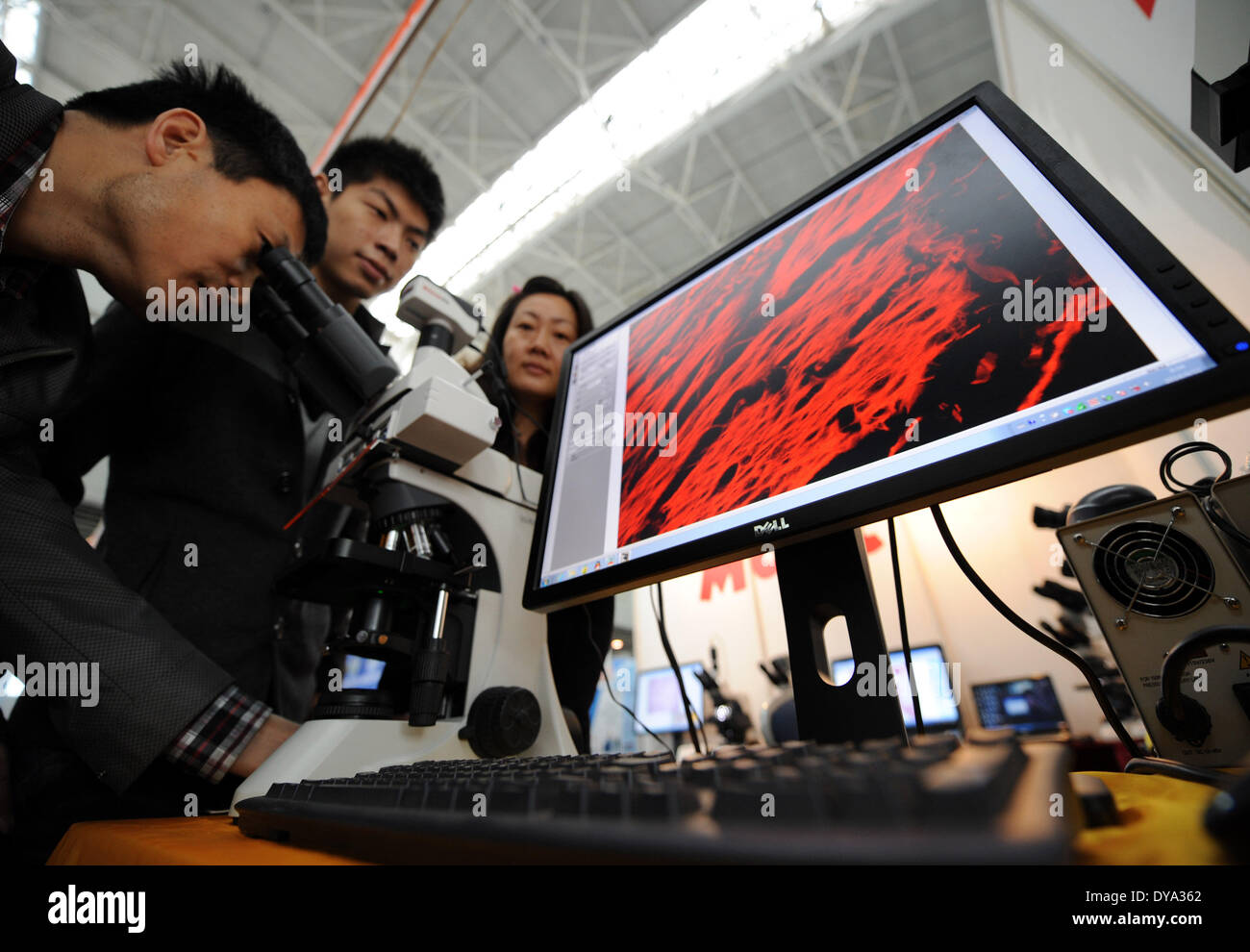 Nanjing, China . 11th Apr, 2014. Visitors experience a microscopic image processing system during the 2014 China International Education Equipment & Science Exhibition in Nanjing, capital of east China's Jiangsu Province, April 11, 2014. The exhibiton, with the participation of 430 exhibitors from more than 20 countries and regions, is held in Nanjing through April 11 to 13. Credit:  Xinhua/Alamy Live News Stock Photo