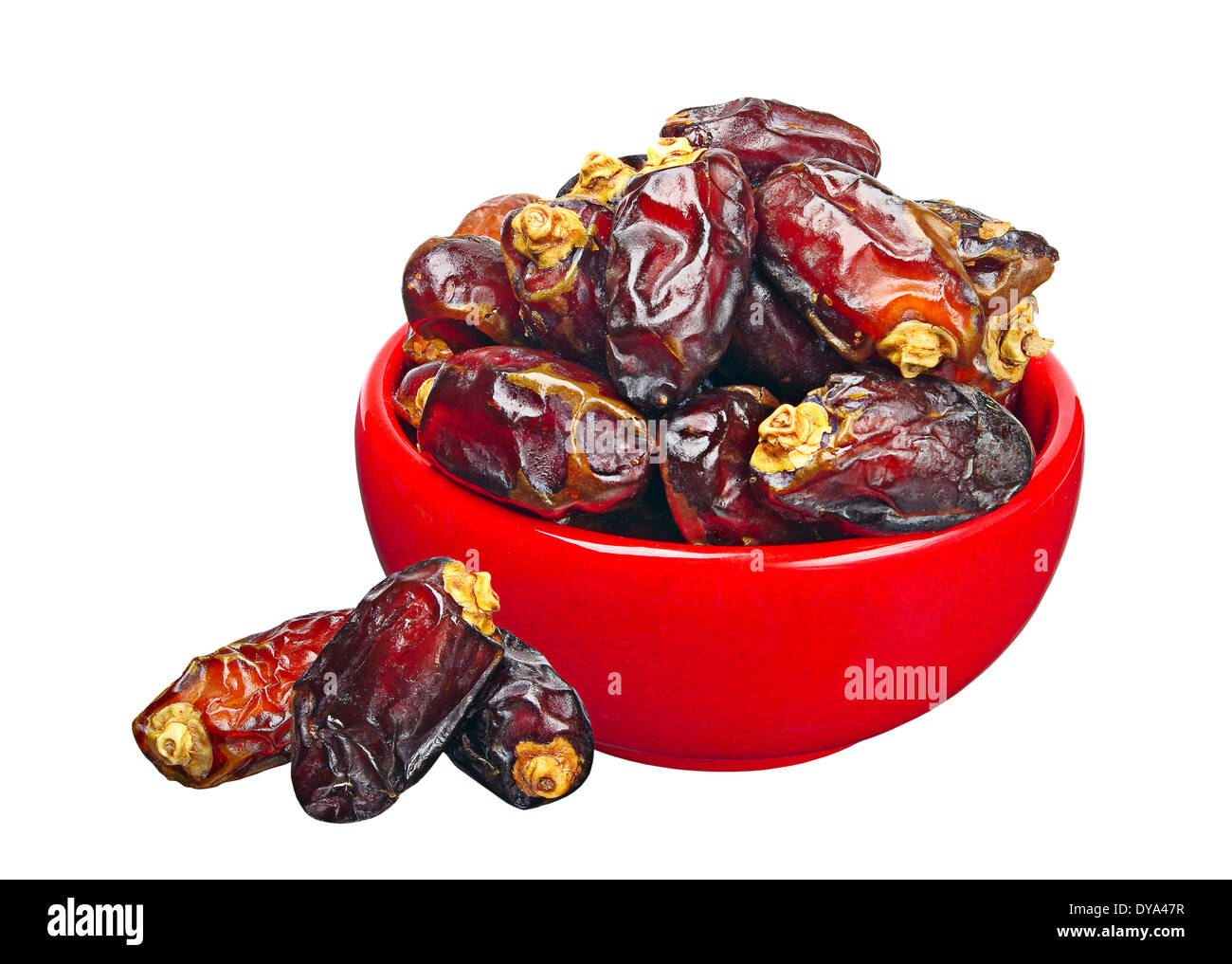 Dates in red ceramic bowl, isolated on a white background Stock Photo