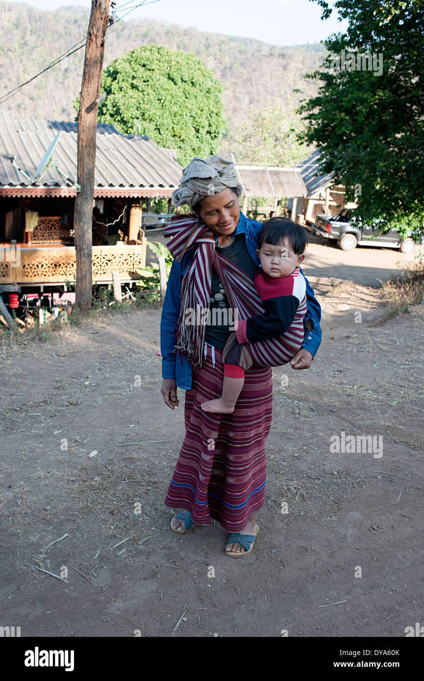 Proud villager looks lovingly at her child. Huay Pakoot village, northern Thailand. Stock Photo