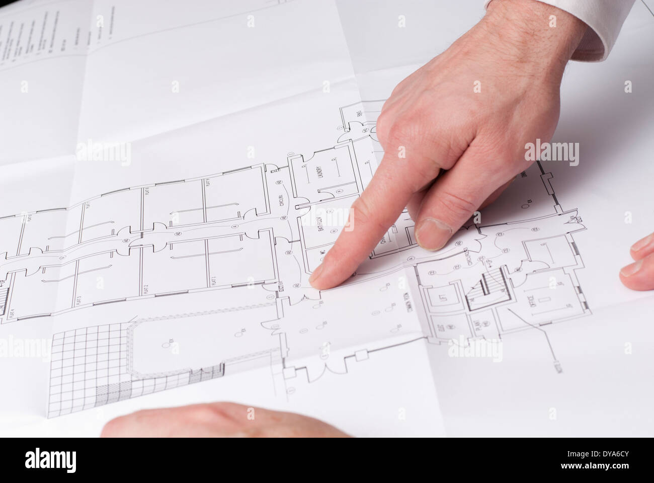 Male hand pointing at floor plan of house Stock Photo