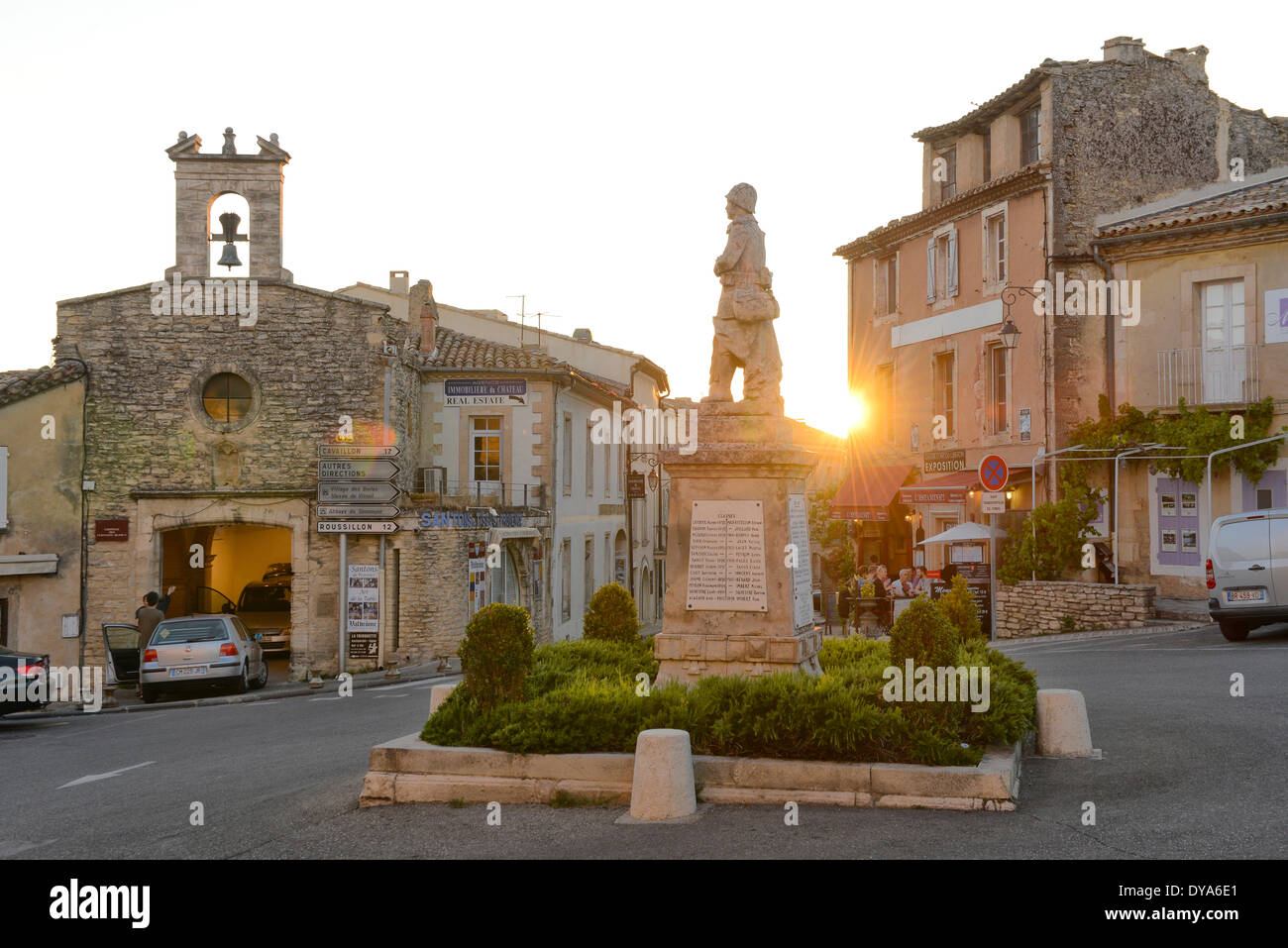 Europe, France, Provence, Vaucluse, Gordes, town, square, monument, sunset, flare, sun, french, village Stock Photo