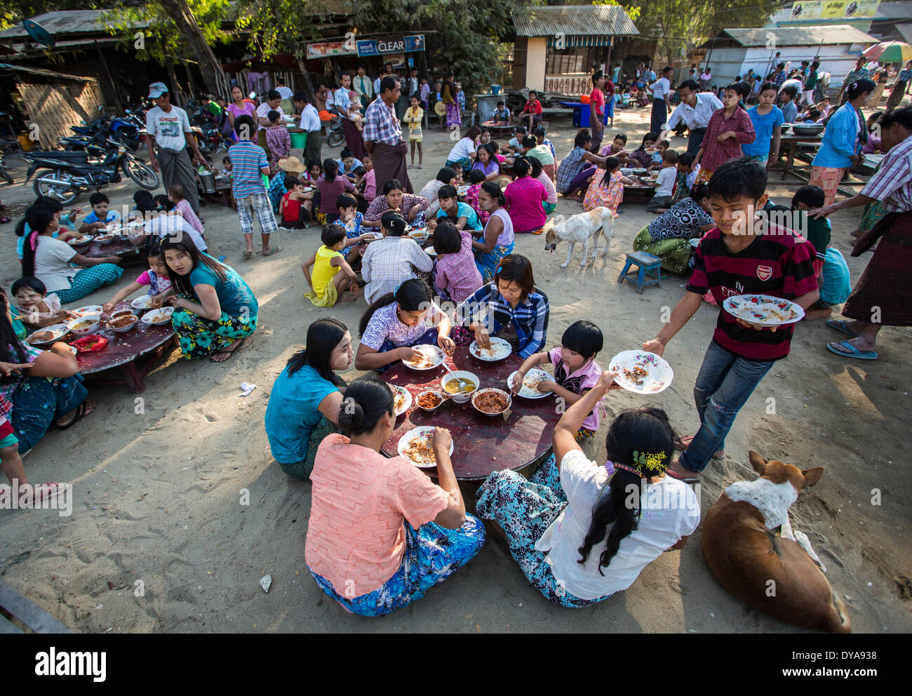 Mandalay Myanmar Burma Asia Sagaing celebration colourful culture dishes distributing family eating fiesta food free gay h Stock Photo