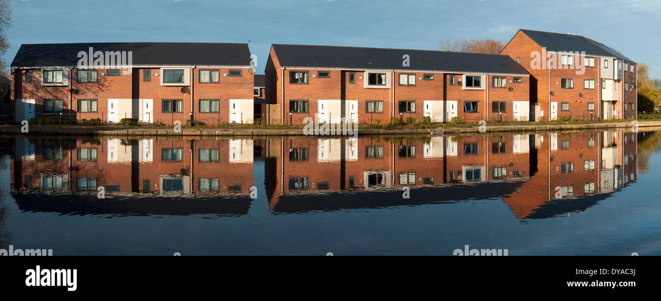 Canalside homes reflected in the Ashton Canal, Droylsden Marina, Tameside, Manchester, England, UK Stock Photo