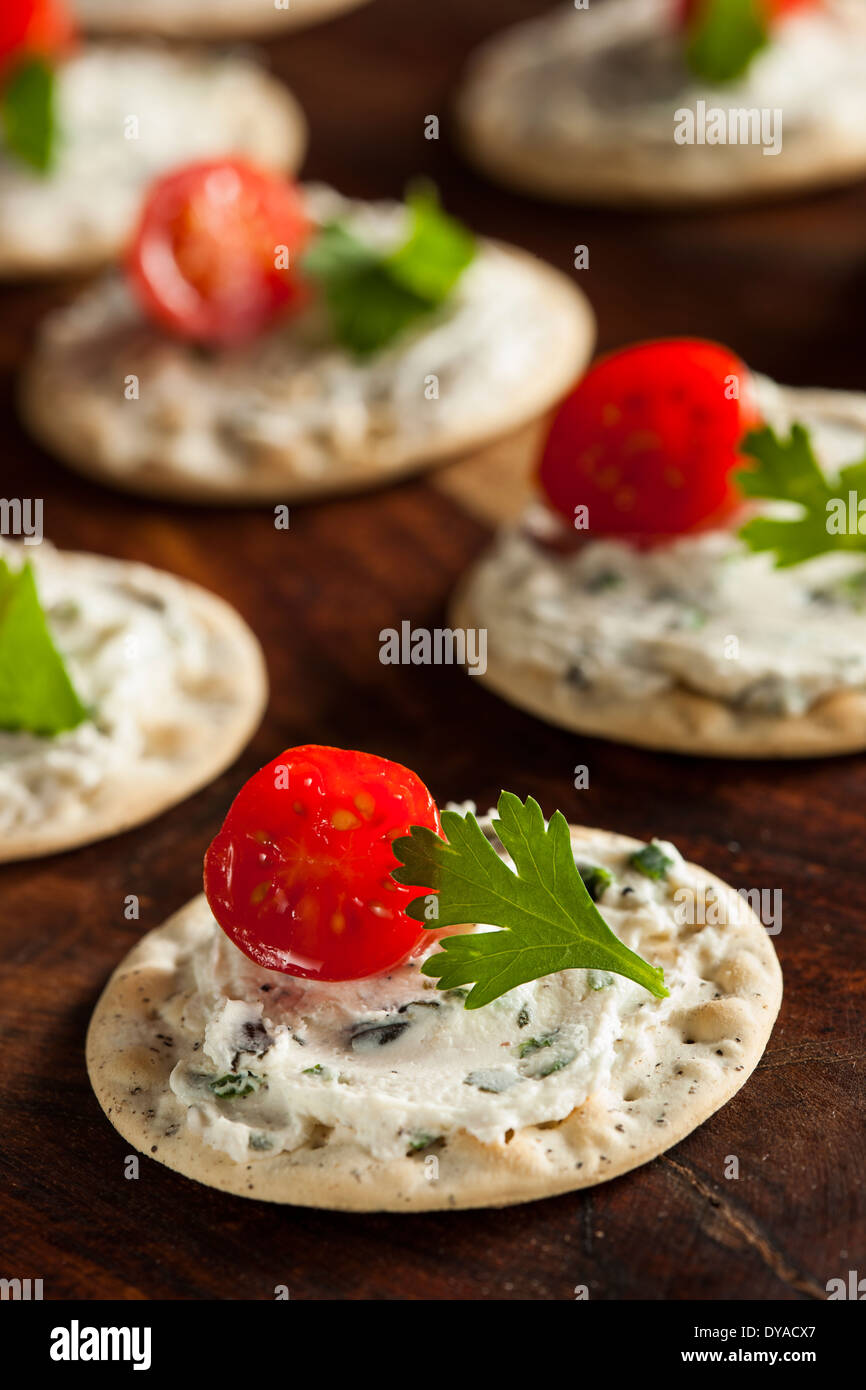 Cracker and Cheese Hors D'oeuvres with Tomato and Parsley Stock Photo