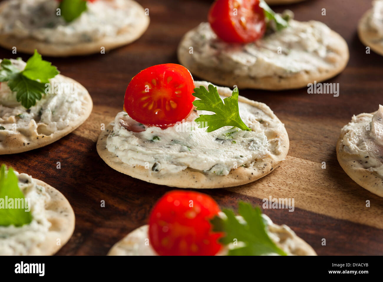 Cracker and Cheese Hors D'oeuvres with Tomato and Parsley Stock Photo
