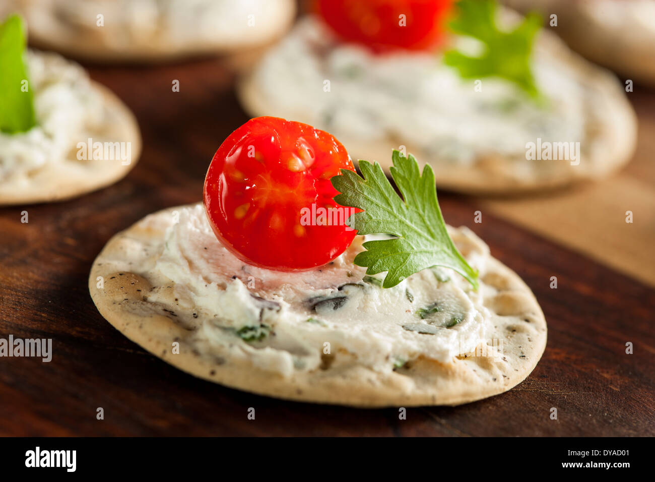 Cracker and Cheese Hors D'oeuvres with Tomato and Parsley Stock Photo