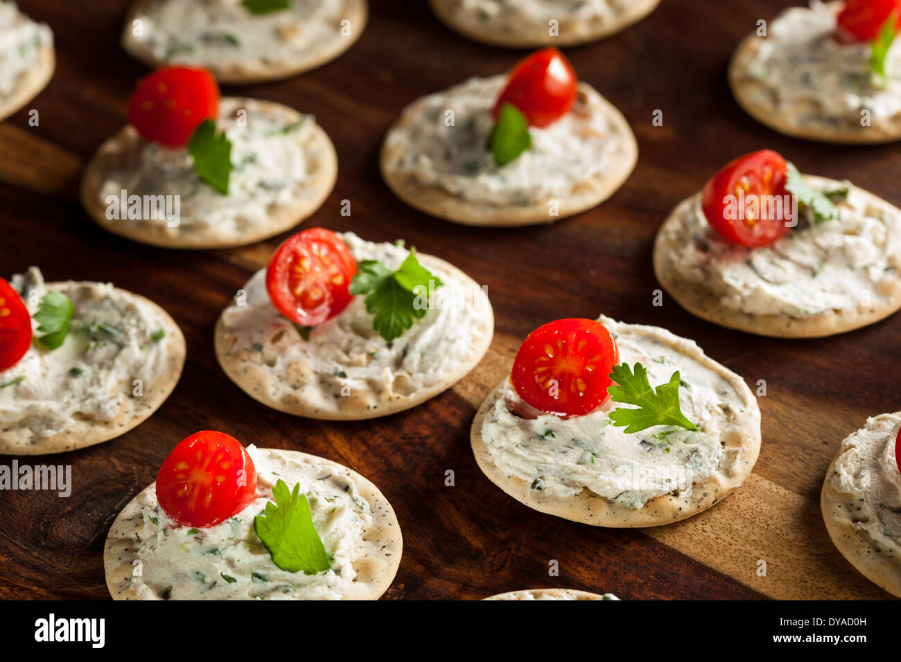 Cracker and Cheese Hors D'oeuvres with Tomato and Parsley Stock Photo