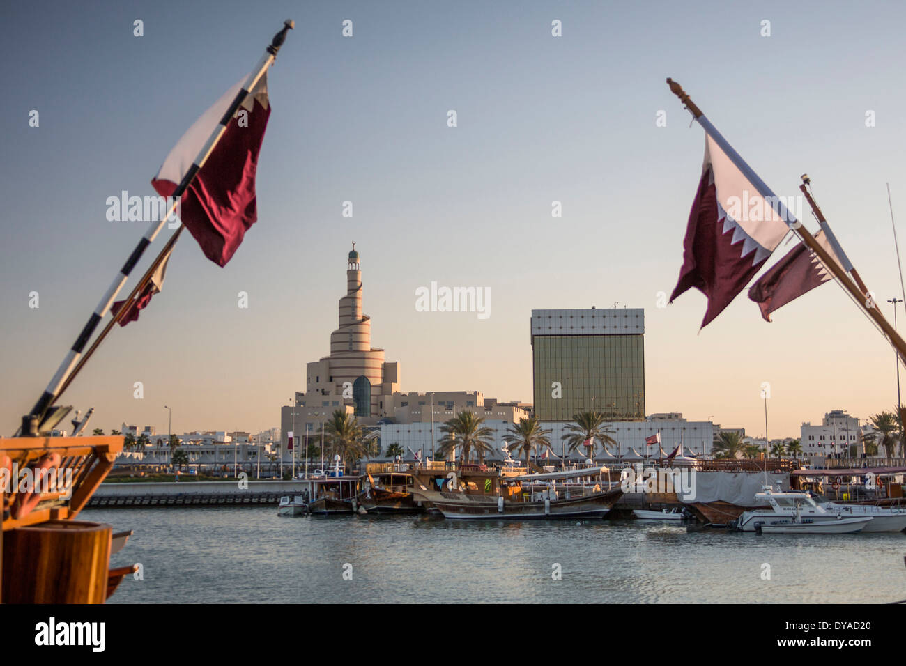 Doha Qatar Middle East architecture boats center city flags harbour Islamic marina minaret mosque old port symbol touristi Stock Photo