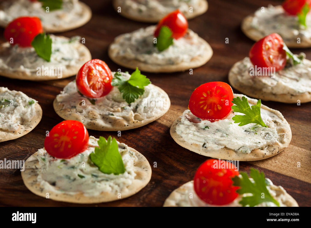 Cracker and Cheese Hors D'oeuvres with Tomato and Parsley Stock Photo