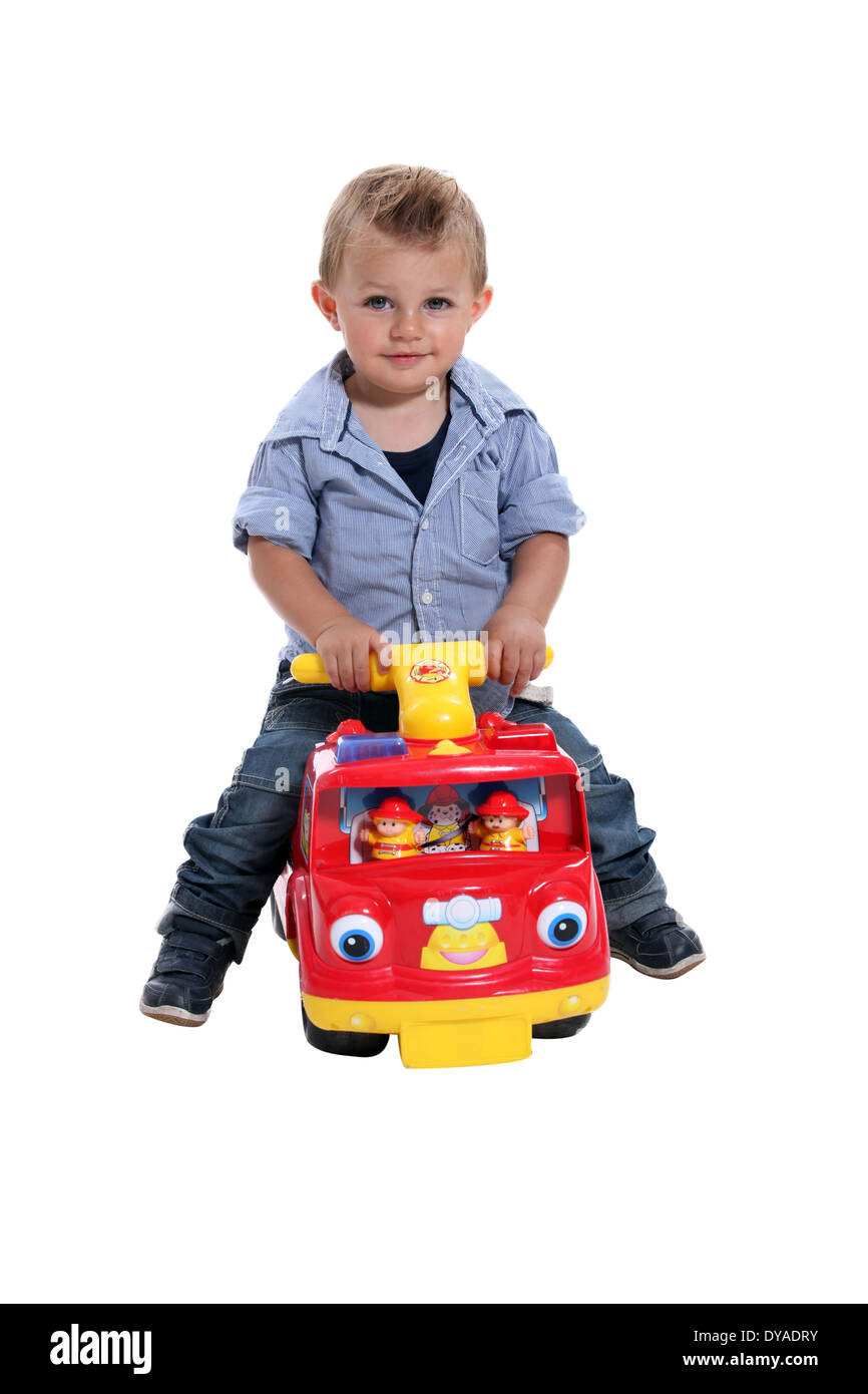 Boy playing on fire engine Stock Photo