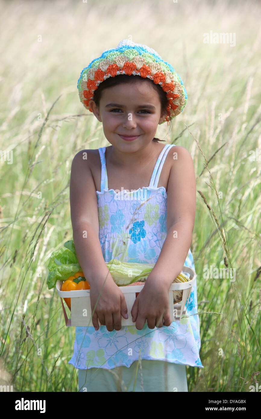 Little girl smiling in a field Stock Photo - Alamy
