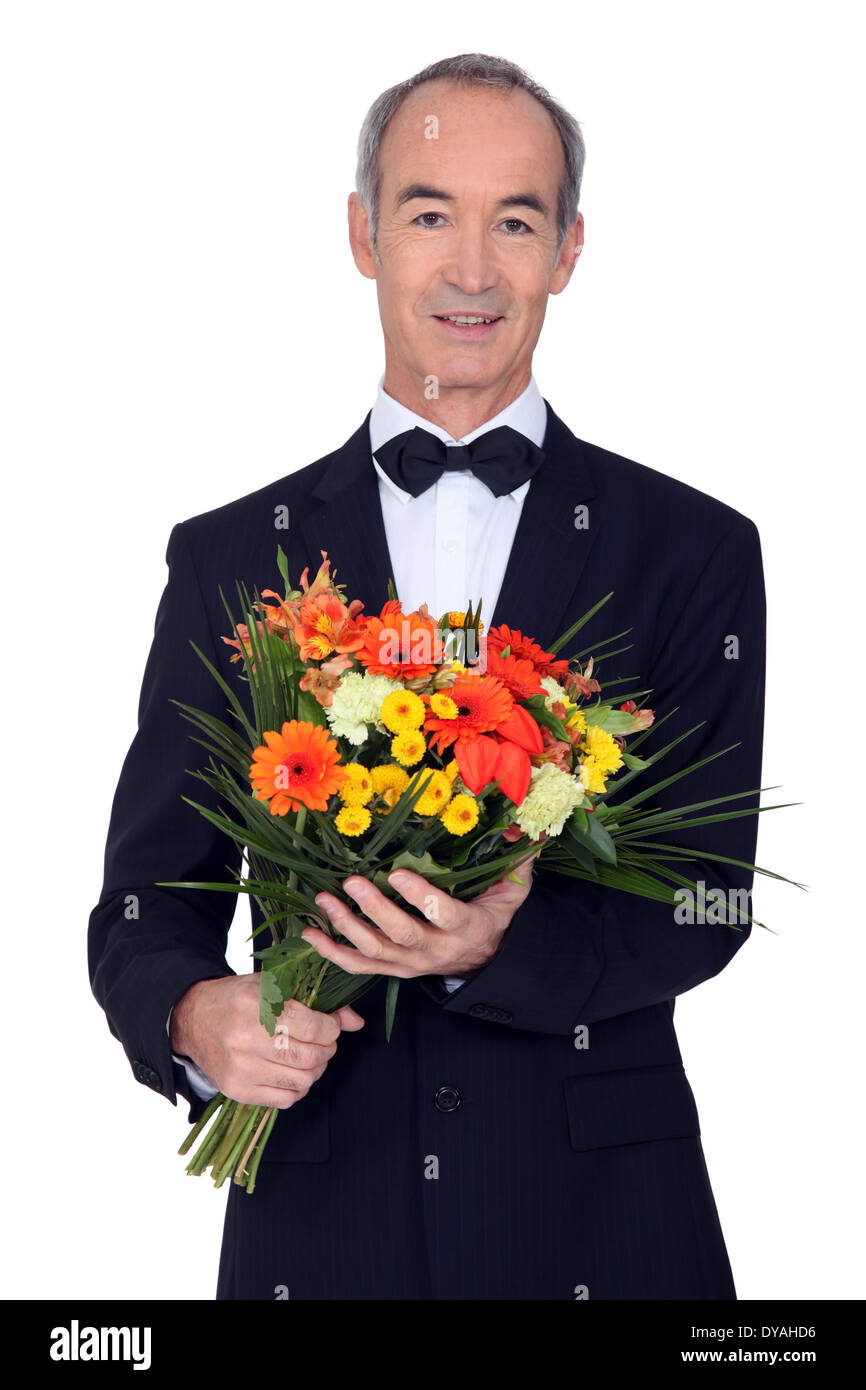 senior man in a suit holding flowers Stock Photo - Alamy