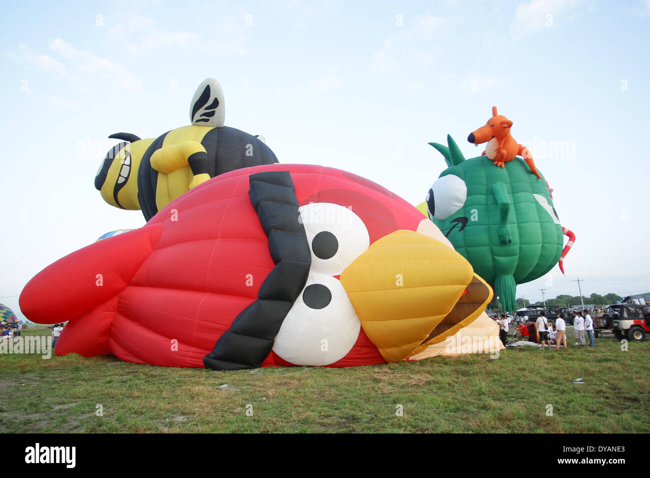 Lubao, Pampanga, Philippines. 11th Apr, 2014. Hot air balloons are inflated as it gets ready for take-off at the Philippine International Hot Air Balloon Festival on April 11, 2014. The Philippine International Hot Air Ballon Festival featured 21 countries with 37 balloons. Credit:  Mark Cristino/NurPhoto/ZUMAPRESS.com/Alamy Live News Stock Photo