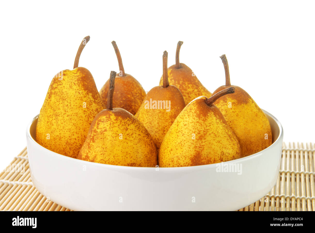 Yellow ripe pears in a white bowl on white background Stock Photo