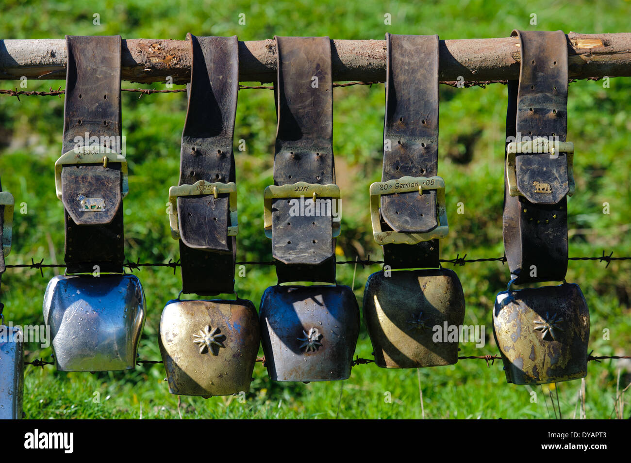 group of cow bells on fence in Bavaria, Germany Stock Photo