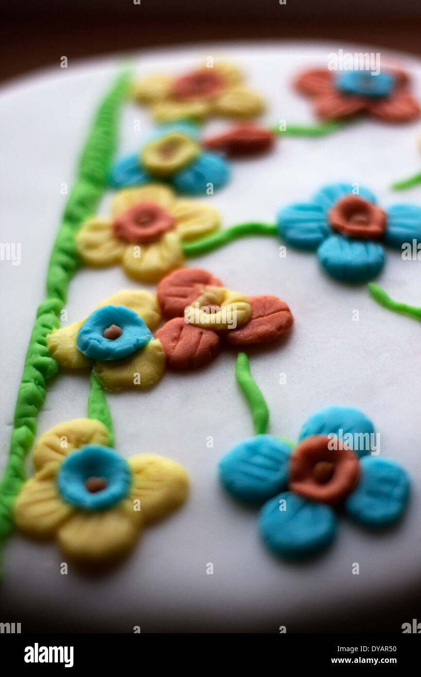 Icing flowers decorate a cake. Stock Photo