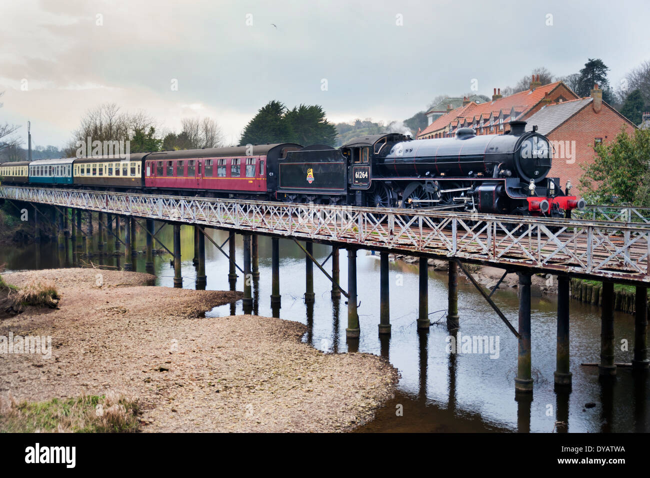 Thompson B1 steam locomotive from the NYMR railway crosses the bridge over the River Esk at Ruswarp on way to the seaside resort of Whitby, 2014. Stock Photo