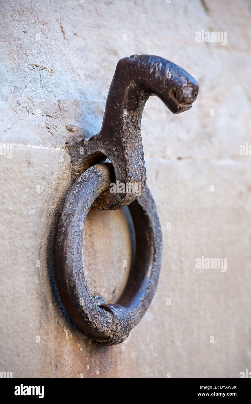 old ring for horses tether on the wall closeup Stock Photo