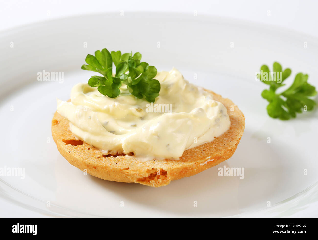 Round cracker with cream cheese spread Stock Photo Alamy