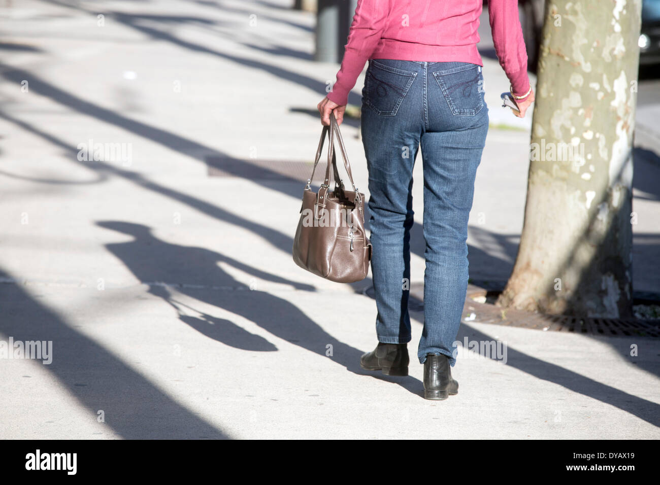 Shadow of woman with handbag shopping street jeans Stock Photo