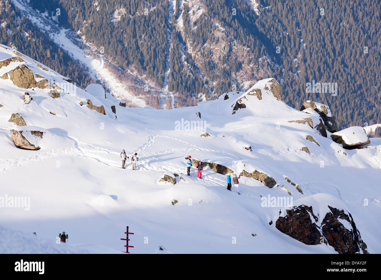 People walk or hike with snowshoes around Plan De L'Aiguille above Chamonix Mont-Blanc. Stock Photo
