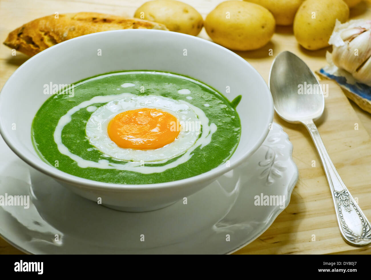 Nettle cream soup with egg cooked at low temperature. Stock Photo