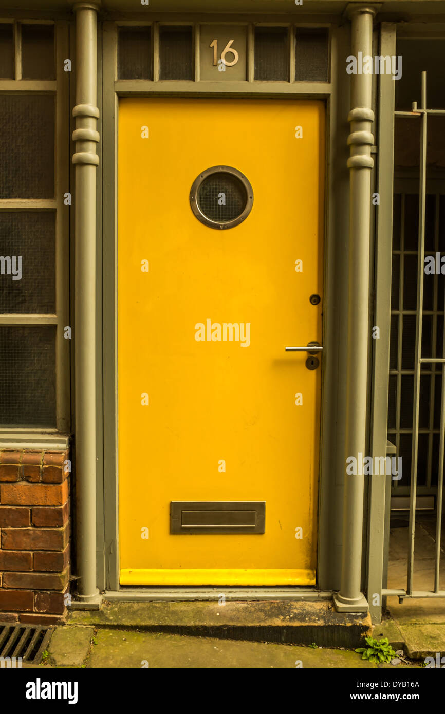 A yellow door at Number 16 Stock Photo