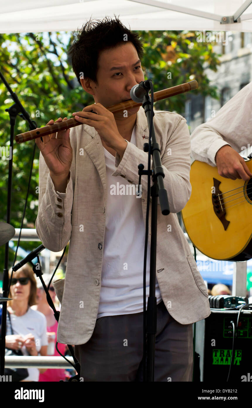 Bamboo flute player performing at the Mardi Gras, part of the Edinburgh