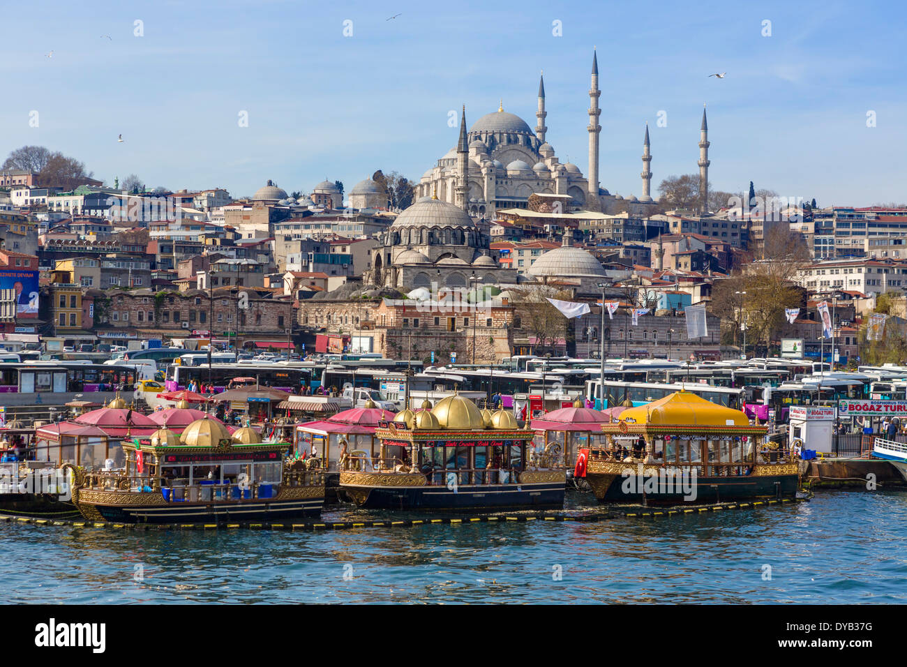 Decorative boats selling fish sandwiches (Tarihi Eminonu Balik Ekmek) with Suleymaniye Mosque behind, Eminonu, Istanbul, Turkey Stock Photo