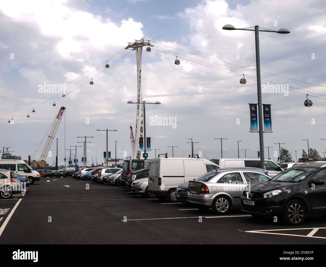 Emirates Air Line cable cars traveling above a car park at the