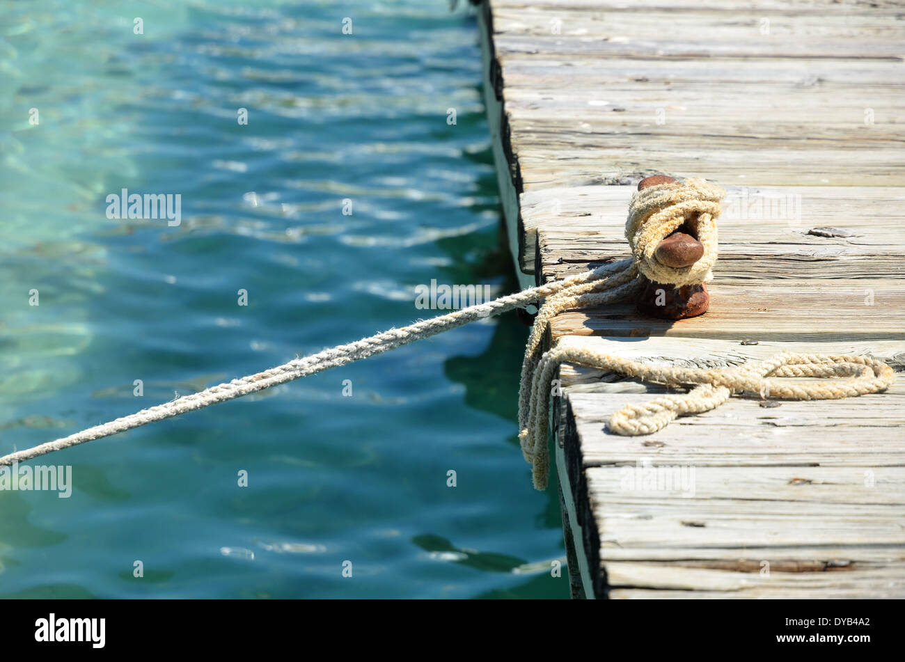 wooden pier with Mooring rope Stock Photo