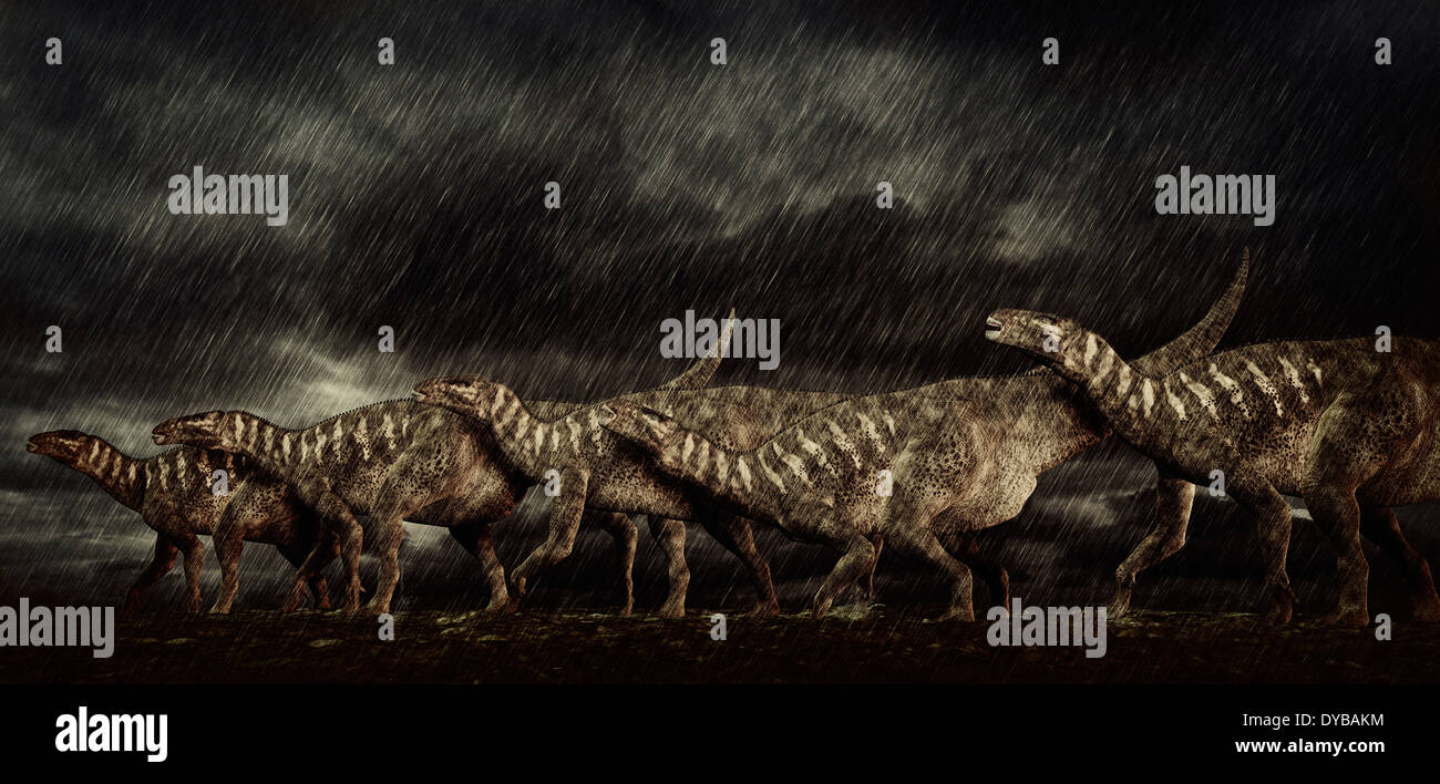 A group of Iguanodons struggle through a storm. Stock Photo