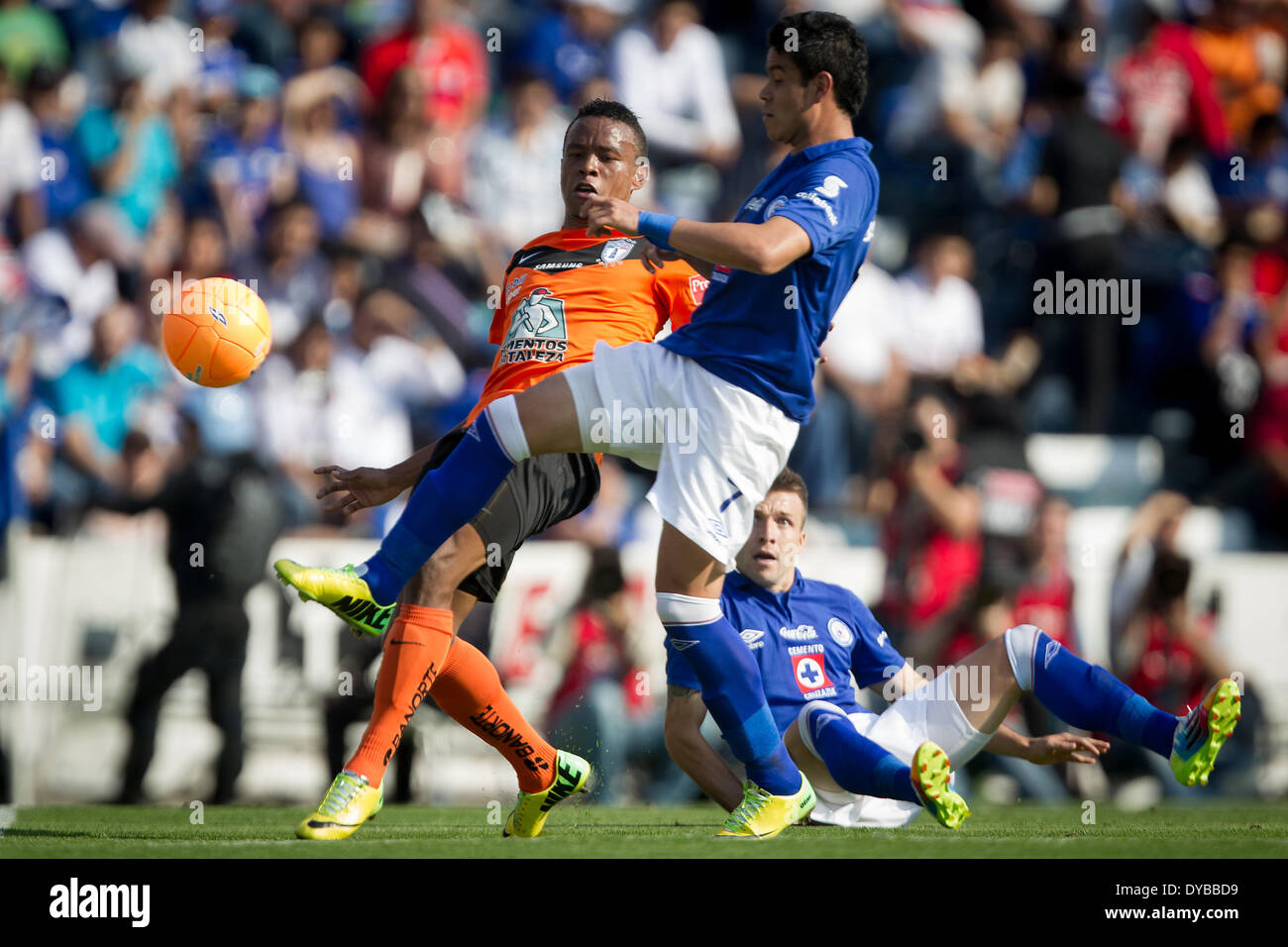 Mexico City, Mexico. 12th Apr, 2014. Cruz Azul's Pablo Barrera (C) vies for the ball with Jhon Freddy Pajoy (L) of Pachuca during a match of the Liga MX held in the Azul Stadium in Mexico City, capital of Mexico, on April 12, 2014. Credit:  Pedro Mera/Xinhua/Alamy Live News Stock Photo