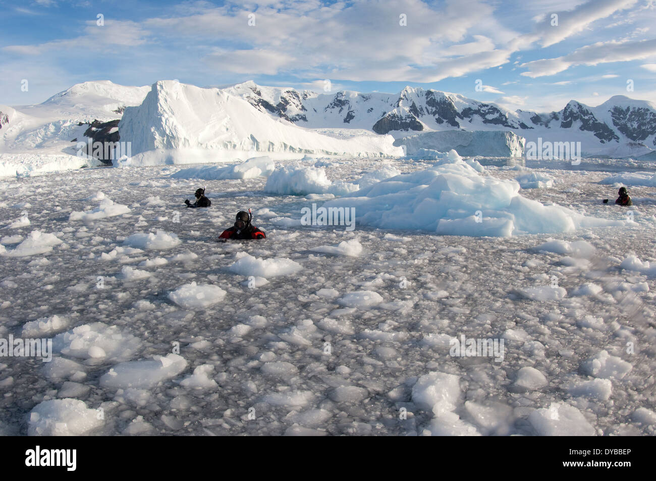 Filmmakers, photographers and scientists at work in brash ice behind Danco Island, Antarctica, during the Elysium Expedition. Stock Photo