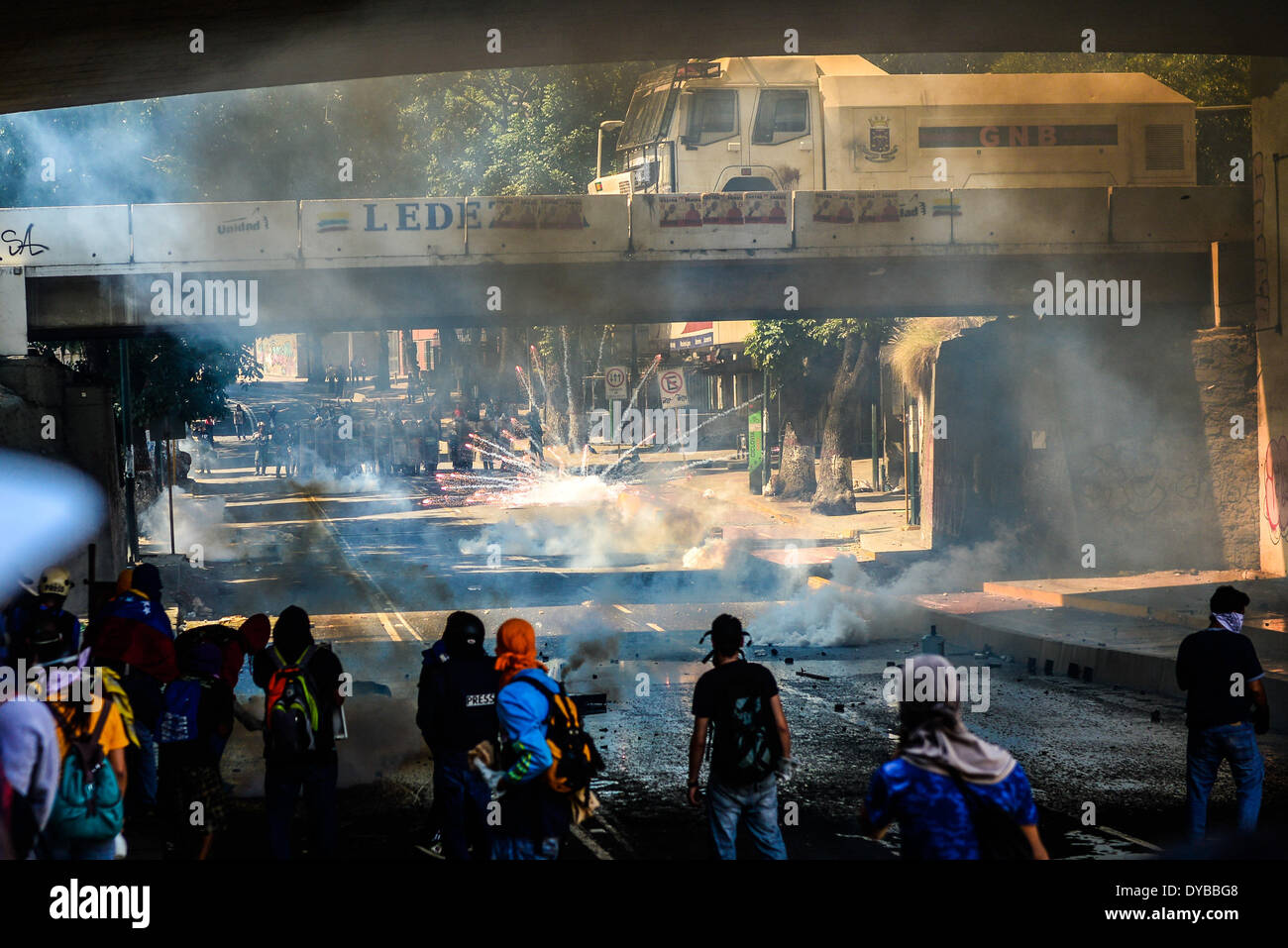 Caracas, Venezuela. 12th Apr, 2014. Members of the Bolivarian National Police and the Bolivarian National Guard try to disperse demonstrators during an anti-government student protest in Las Mercedes, Caracas, Venezuela, on April 12, 2014. Credit:  Carlos Becerra/Xinhua/Alamy Live News Stock Photo