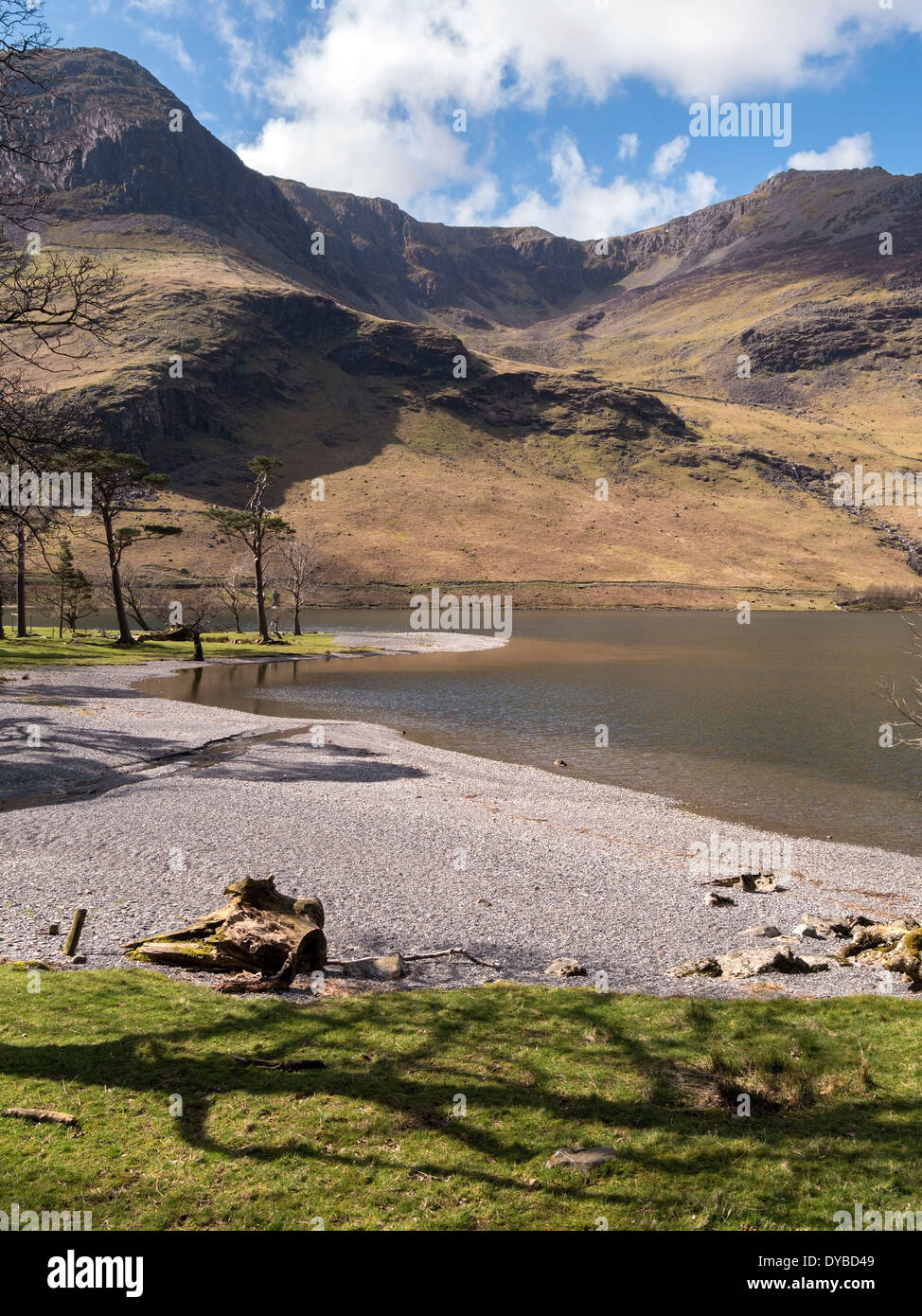 Lake Buttermere shoreline with mountain range of High Crag, High Stile, Grey Crags and Burtness Comb corrie below, Cumbria, UK Stock Photo