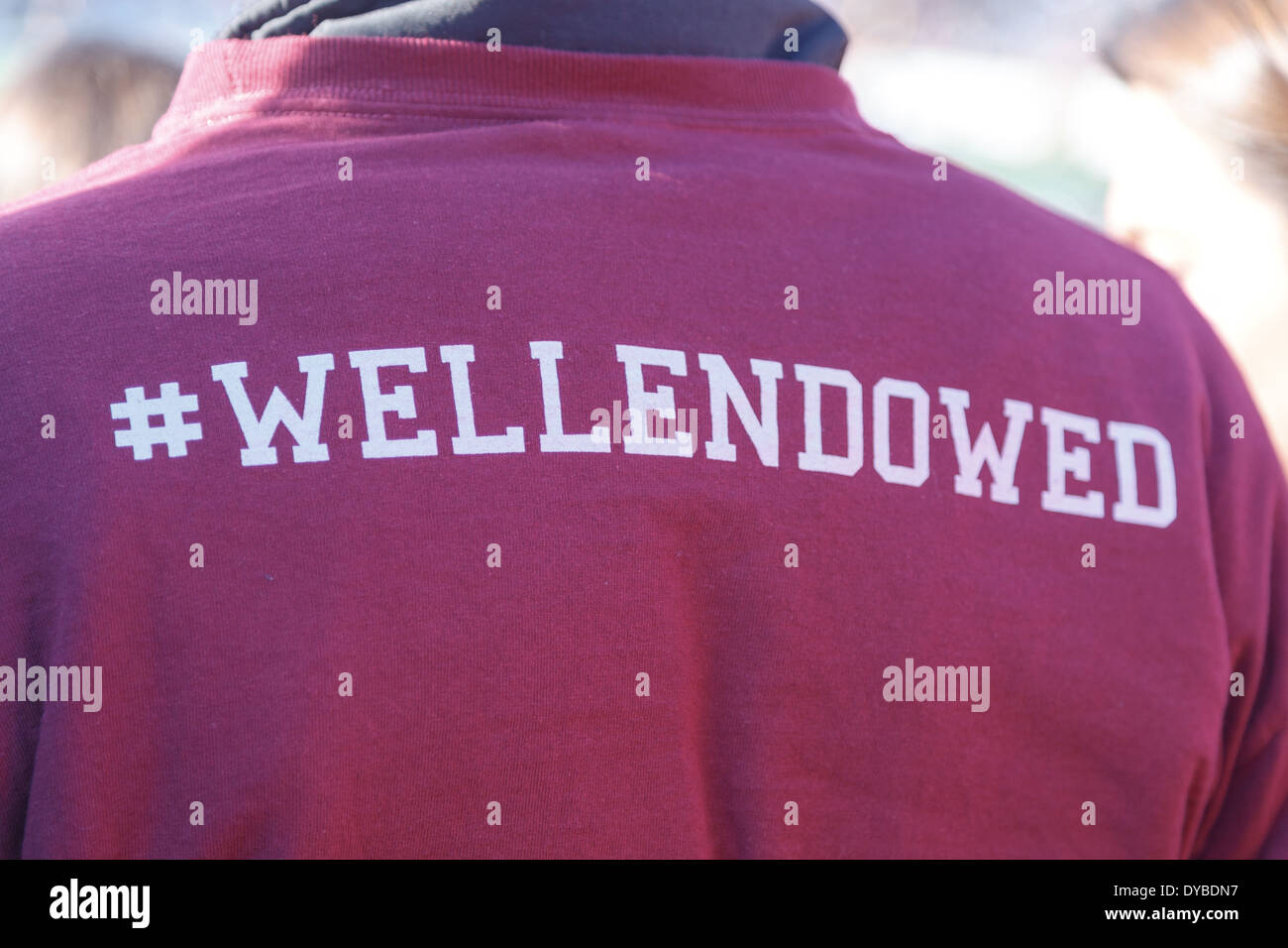 '#wellendowed', referencing Harvard's ample endowment, on the back of a sweater at a Harvard-Yale game in New Haven, CT in 2013. Stock Photo