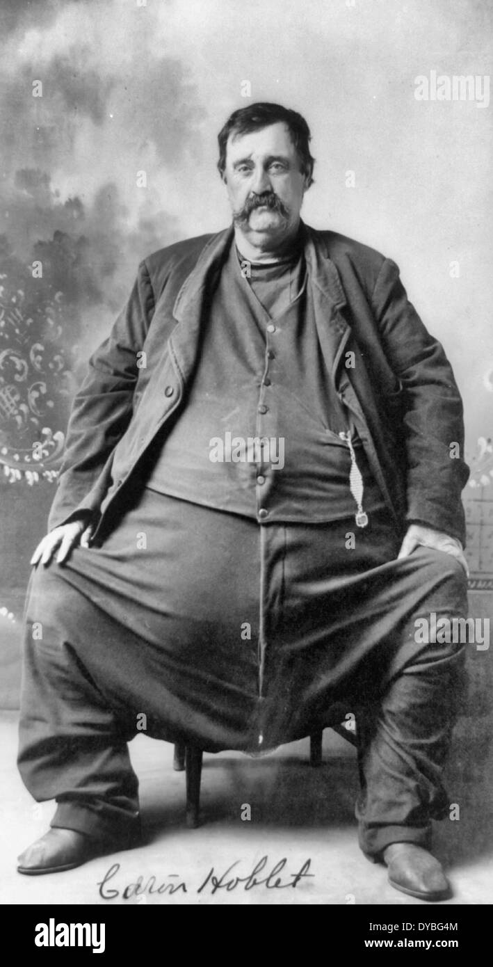 C- Hoblet.  Enormously fat man, seated, full length, facing slightly left. 1909 Stock Photo