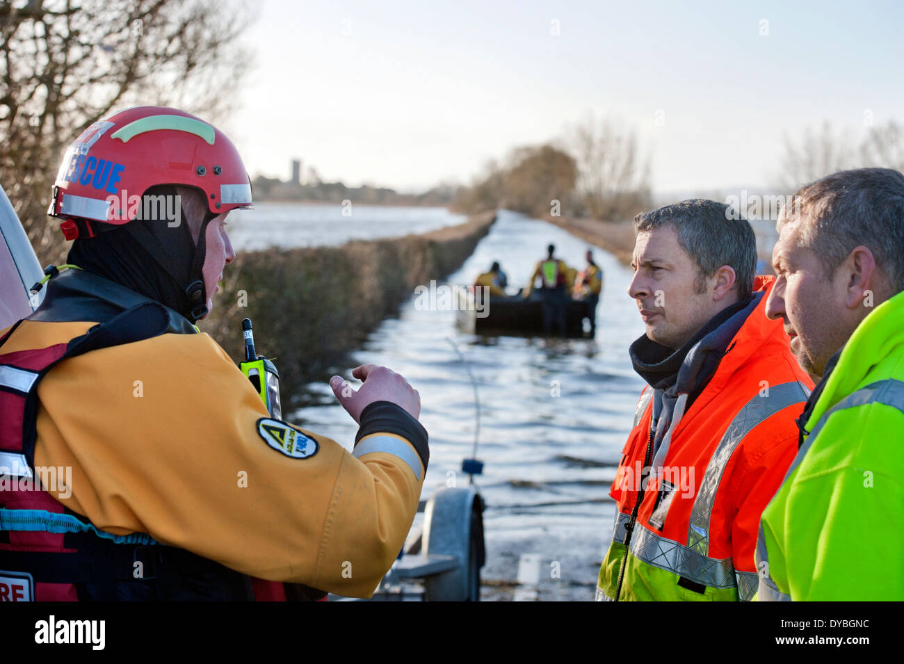 Flooding on the Somerset Levels - a flood rescue team operate a boat between Langport and the cut off village of Muchelney Stock Photo